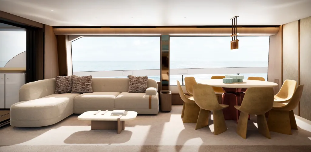 Salone dell'Azimut Fly 82 con divano bianco, tavolo da pranzo rotondo e vista sul mare