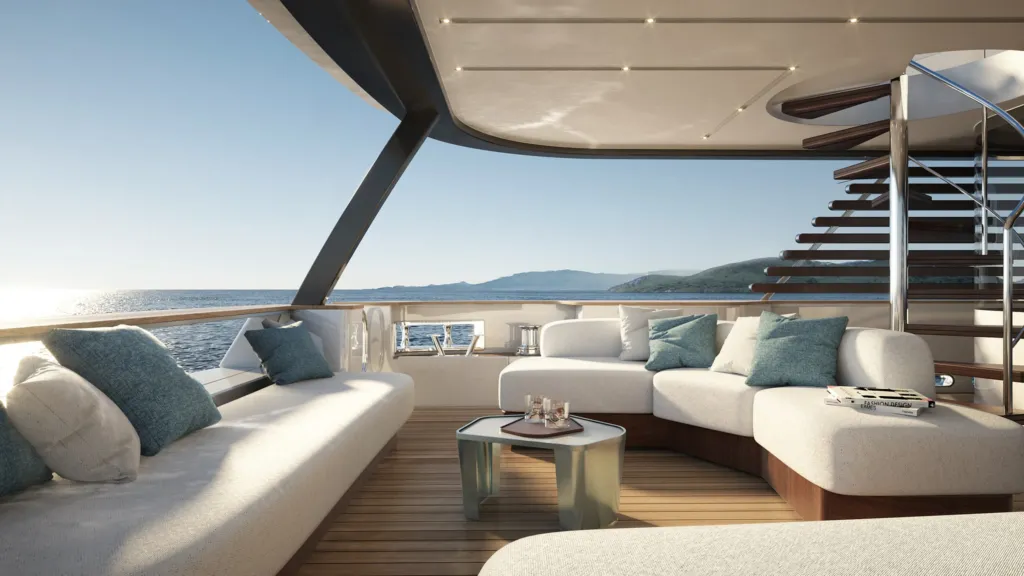 Lounge esterna del Magellano 30M con divani bianchi e scala verso il ponte superiore