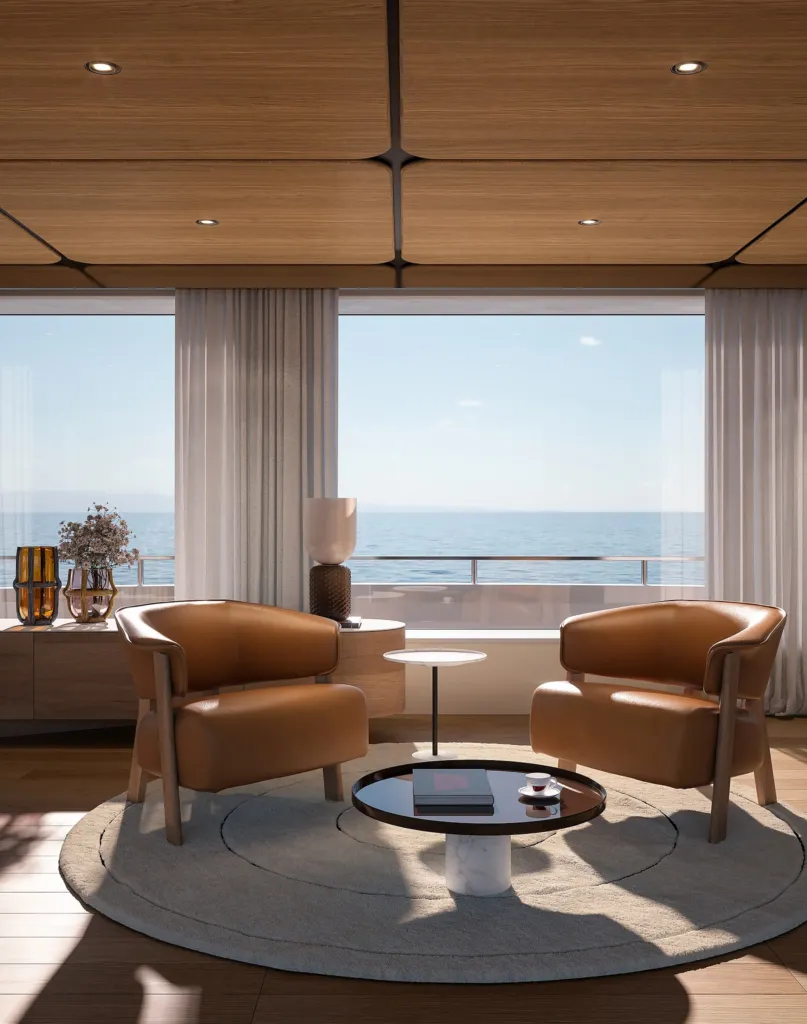 Coppia di poltroncine Cassina in pelle cognac su tappeto rotondo nel salone di uno yacht