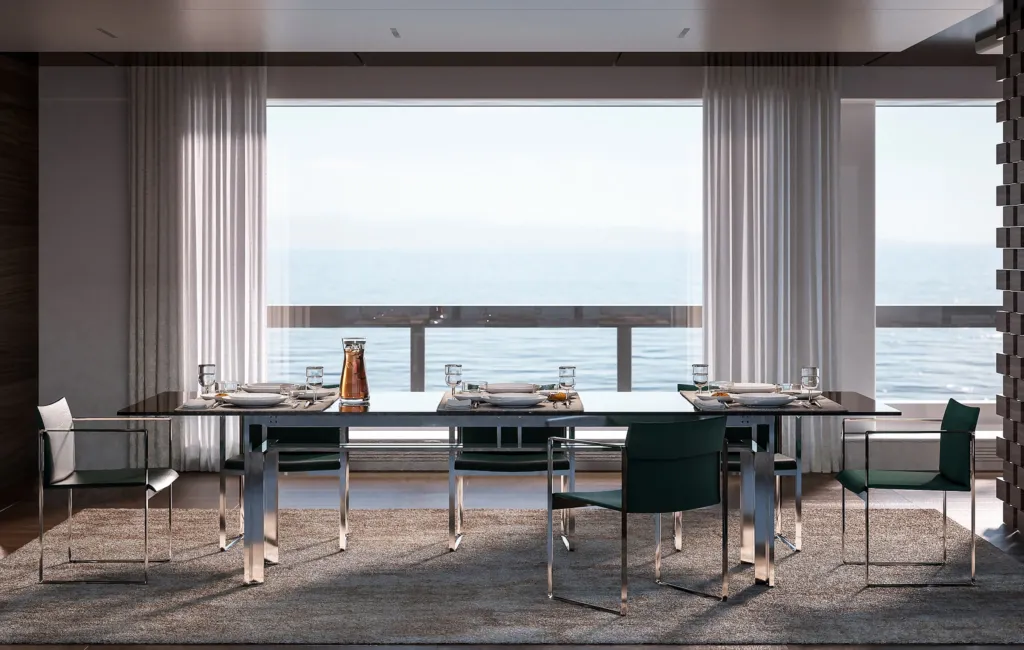 Zona pranzo di uno yacht con tavolo in vetro e sedie Cassina davanti alla vetrata sul mare