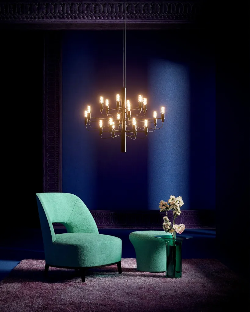 Fluo, stanza blu notte con poltrona verde smeraldo e lampadario a candele