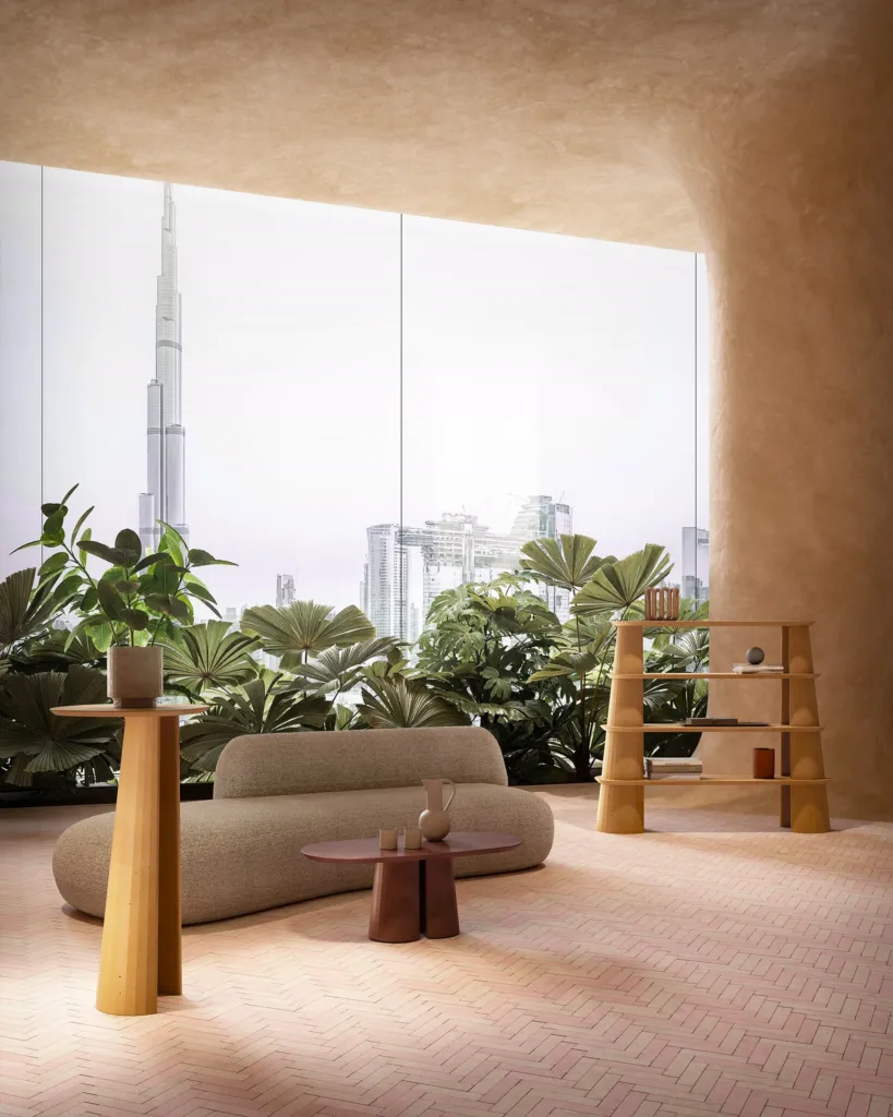 Lounge con divano curvo e tavolini in cemento Forma&Cemento davanti allo skyline di Dubai