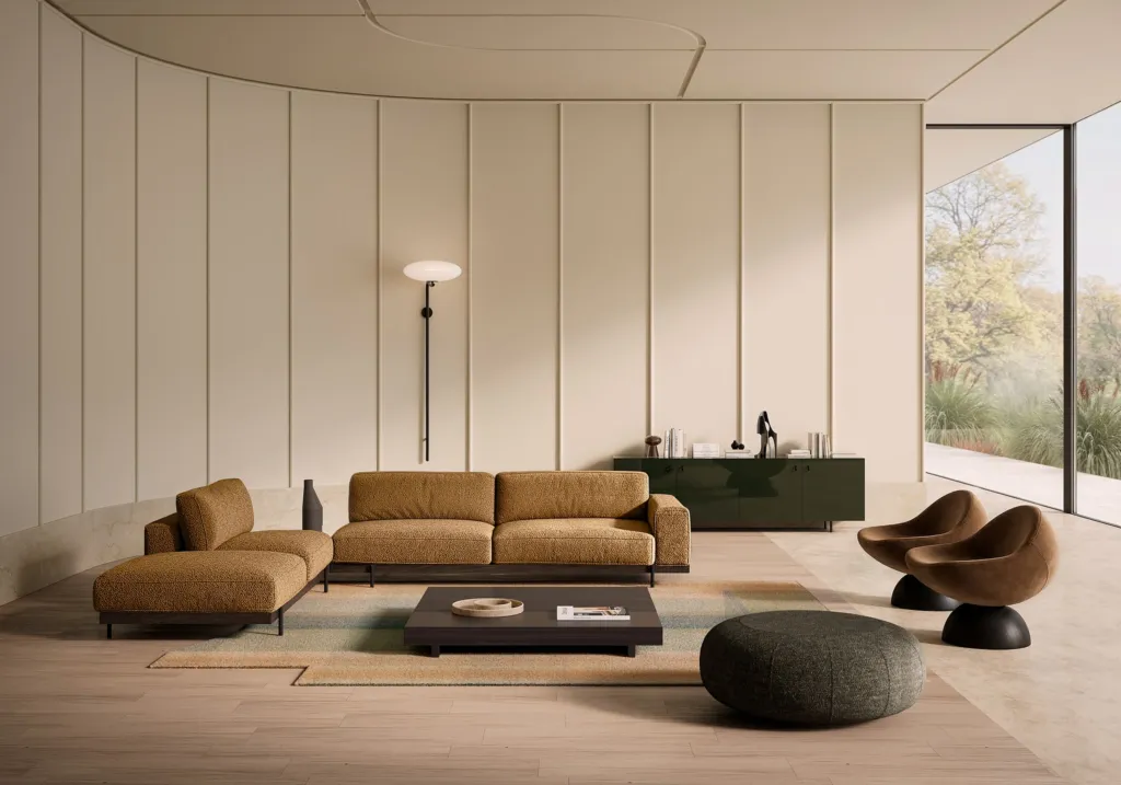 Render di un living Nube con parete curva, divano modulare color caramello e due poltrone