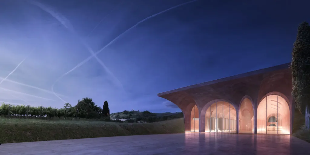 Esterno notturno di una cantina vinicola con arcate illuminate, progetto Rossiprodi Associati